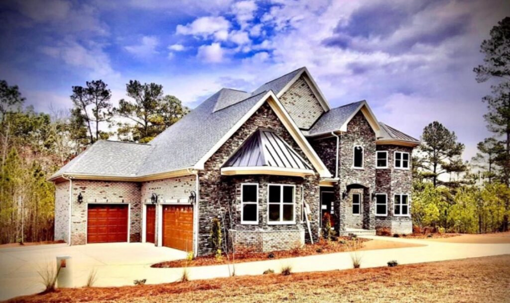 Homeowners reviewing custom floor plan options with builder at Fairmont home design meeting,Construction team reviewing plans beside active building project in Fairmont