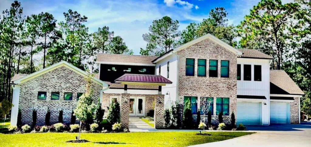 Homeowner discussing custom house plans with builder at residential design consultation table, Experienced contractor reviewing site plans and construction progress with project team